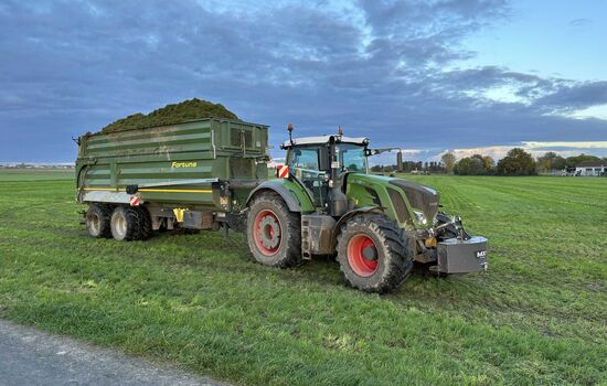 Traktor transportiert auf einem zwei Achs Anhänger Erde